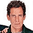 Pixelated image of a person with short brown hair wearing dark clothing, positioned next to text labels on black and white backgrounds.