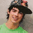 A pixelated image of a person in a green shirt and dark cap with pink flowers, next to text reading 'If Joe Jonas said breathing wasn't cool 95% of teenage girls would be dead' on white background.