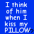 Blue background with white pixelated text repeating 'I think of him when I kiss my PILLOW' and small black heart symbols, arranged in a pattern