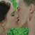 Two figures in close physical proximity with one figure's mouth near the other's cheek, green hair and clothing visible, pixelated rendering.