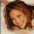 Static 50x50 pixel icon showing a smiling woman with brown hair against a light background, rendered in low-resolution pixel art style.
