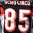 Pixelated sports jersey with number 85, orange text reading Ocho and Cinco on black background.