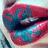 Pixelated close-up of lips with red and blue coloration, showing a mouth in mid-expression against a light background.