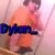 A person in an orange shirt and dark pants stands in a room with light-colored walls, holding a phone to their ear.