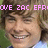 Pixelated image of a smiling person with brown hair, wearing a blue and white shirt, overlaid with pink text reading "OVE ZAC EFR".