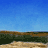 Animated sequence of a geyser erupting against blue sky and brown-green terrain, showing progressive water height changes