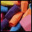 Pixelated animation of a character's arms holding a pink object with text 'I WISH I COULD ERASE YOU' changing color across frames.