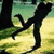 Silhouette of a figure in dynamic pose against grassy background with tree trunks, showing motion across frames.