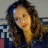 A 48x48 pixel animated buddy icon featuring a woman with long brown hair and red lipstick on the left side, next to large blue text reading "honey" on a dark background.