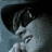 A 48x48 pixel animated contact sheet showing three sequential frames of a person wearing sunglasses and a cap, with visible motion in facial expression and hand position across the sampled frames.