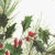 Static pixelated image of green holly leaves with red berries against a light background.