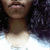 A person with curly dark hair and a white shirt appears in a of four with varying facial expressions and lighting