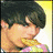 Pixelated image of a person with dark hair holding a yellow cookie near their mouth, next to a large pink 'C' and text reading "is for Cookie! that's good enough for me <3".