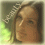 A pixelated portrait of a person with brown hair and light skin, set against a greenish background with faint text overlay.