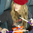A 48x48 pixel animated buddy icon featuring a cartoon character with long blonde hair and red beanie, alongside text reading "NEW YORK MINUTE" in layered blocks on the right side.