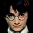 Pixelated image of a person with dark hair and glasses, wearing a white collared shirt against black background with text below.