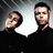 Two pixelated figures in dark clothing against a gradient background with a white speech bubble between them.