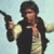 Pixelated static image of a character holding a blaster pistol, wearing a dark vest over a light shirt with red accents, against a pale blue background.