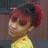 Pixelated image of a person with reddish-brown hair styled in two large side buns, wearing a yellow garment with a red detail on the chest.