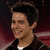 Pixelated image of a person with dark hair and brown jacket, next to pink text blocks on black background.