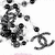 Black-and-white animated icon with a stylized Chanel logo and scattered circular shapes moving across the frame.