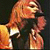 Pixelated image of a person with long hair holding a microphone next to text reading "Kurt Cobain 1967-1994" on a black background.
