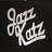 Pixelated white text on black background forms stylized cursive letters with curved strokes and open counters.