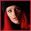 Three pixelated views of a person with long red hair against dark backgrounds, showing different head angles and expressions.