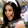 A person with long dark hair wearing a white headband and pink top, with visible text on clothing.