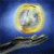 A pixelated image shows a yellow and white circular object with a blurred face-like shape against a blue background, with a dark horizontal line below.