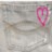 A static image with a blurred background and a pink, pixelated, heart-shaped icon on the right side.