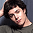 A pixelated image of a person with dark hair resting their head on their hand, accompanied by pixelated text about life at 16.