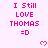 Pixelated pink text and hearts on a light pink background with a gray bottom-right corner, repeating 'I Still LOVE THOMAS =D' in a pattern