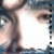 Pixelated close-up of a person's face with visible eyes, nose, and mouth against a blue and white background.