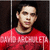 Pixelated image of a person wearing a red sweater with a dark collar, standing against a dark background with a vertical light stripe on the left.