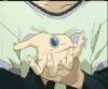 Animated sequence showing a character's hands holding a blue gem, transitioning to close-ups of the character's face with tears and a distant figure under a spotlight.