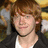 A pixelated image of a person with brown hair wearing a black jacket over a white shirt, displayed in four with varying text overlays