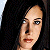 A pixelated contact sheet showing two frames of an animated icon featuring a woman's face on the left and green text reading "Original Icons .com" on the right against a dark background.