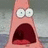 Two identical pink cartoon characters with wide eyes and open mouths against a blurred background.