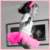 Pixelated icon of a figure in white dress with pink accents, black hair tied with pink bow, standing before two dark square shapes on gray background.