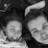 Black-and-white pixelated image showing two circular faces with smooth shading and a curved shape above them against a dark background.