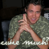 A person in a camouflage shirt with hands clasped under chin, smiling, with handwritten text 'cute much?' at bottom.