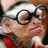 Pixelated image of a person with light skin wearing a white cap and dark-rimmed glasses, red clothing visible at the bottom, against a brown background.