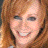 Static 48x48 pixel icon showing a close-up of a person's face with light brown hair and visible teeth in a smile, rendered with heavy pixelation and dithering effects on a transparent background.