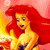 Pixelated image of a character with long red hair, yellow skin, and a yellow top with blue accents against a pink and yellow gradient background.