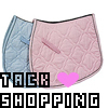 Two quilted saddle pads in light blue and pink with diamond stitching, overlapped, with pixelated text and a heart symbol below.