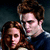 Two figures with brown hair, one in dark clothing embracing another from behind against a dark background.