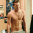 A pixelated image of a shirtless man standing in an indoor setting with text overlays reading "No Need 2" and "Sexy Never Left Bring It Back."