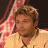 A 48x48 pixel animated contact sheet showing two frames of an American Idol-themed buddy icon with a person on the left and a blue logo on the right.