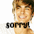 Pixelated image of a smiling person with light brown hair, wearing a white top, with overlaid text reading "sorry! he's just" and "too cute" in black block letters.